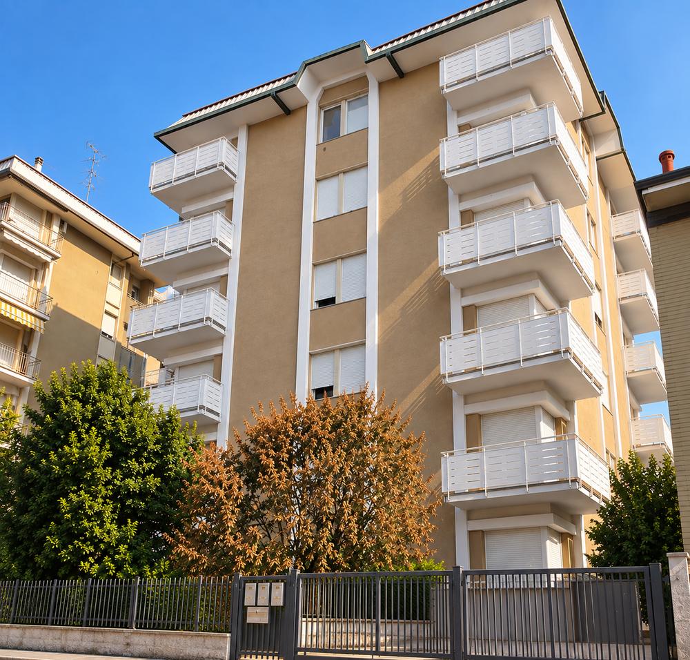 Condominio a cinque piani con balconi bianchi e facciata color sabbia, Busto Arsizio (VA)